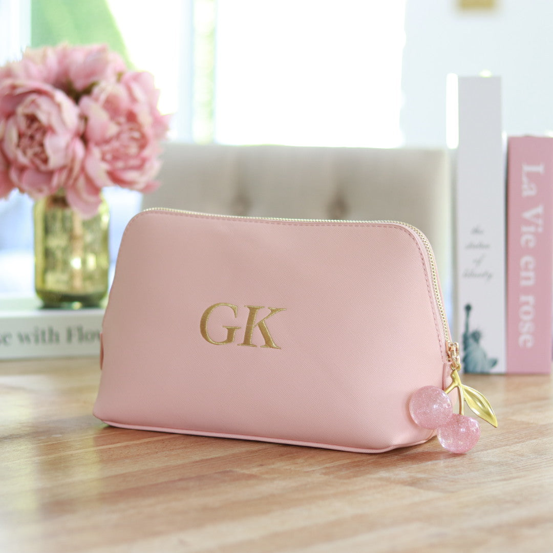 Personalised pink faux Saffiano leather clutch bag with gold embroidered initials and a pink cherry zipper charm, custom makeup bag or gift for her.