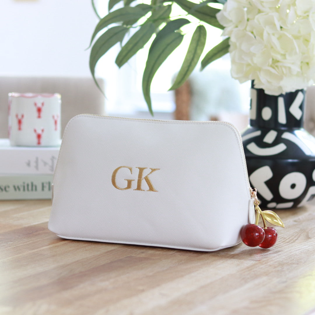 Personalised white faux Saffiano leather clutch bag with gold embroidered initials and a red cherry zipper charm, custom makeup bag or gift for her.