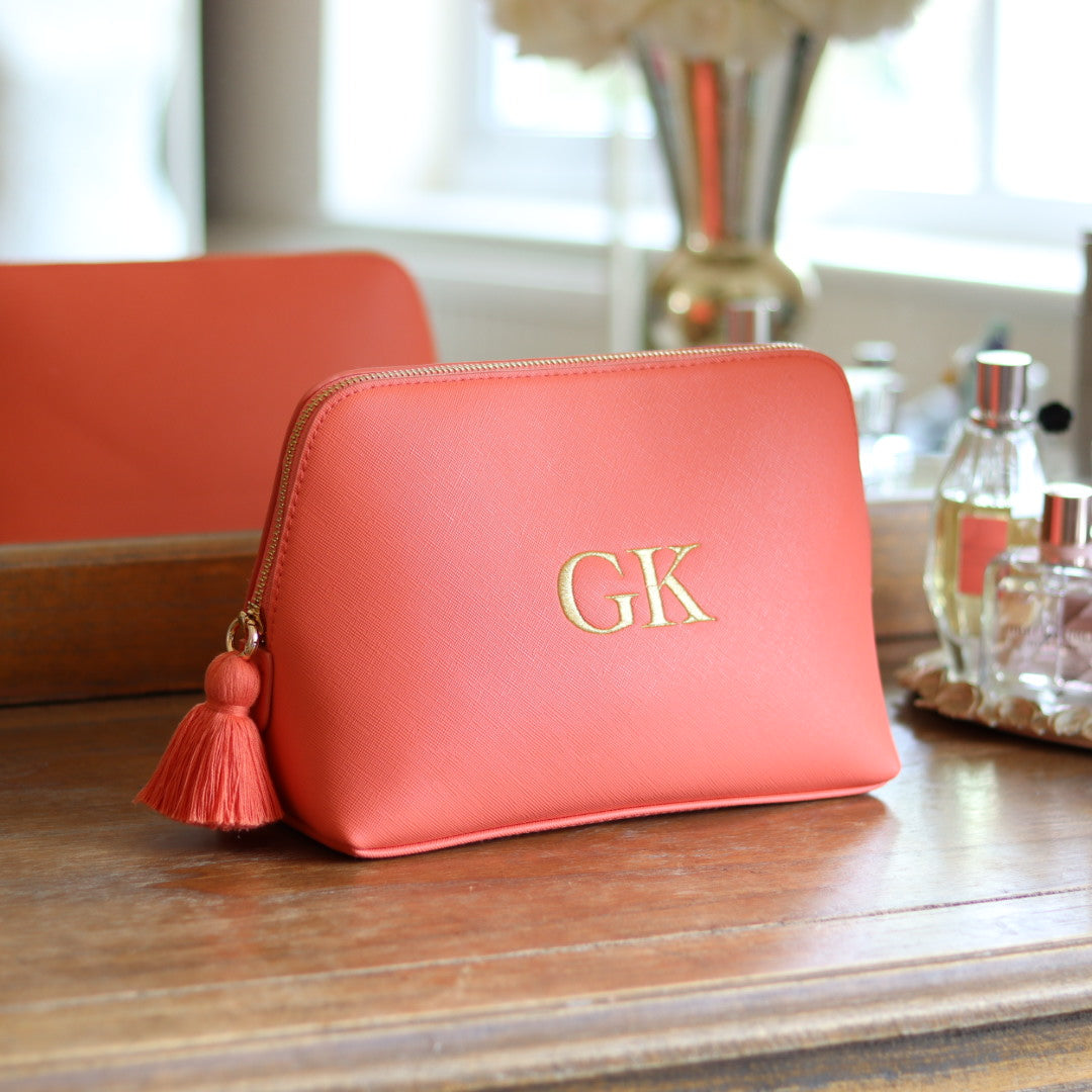 Personalised coral orange faux leather makeup/clutch bag with gold embroidered monogram initials and matching coral tassel zipper. Custom travel, cosmetics pouch gift for her.