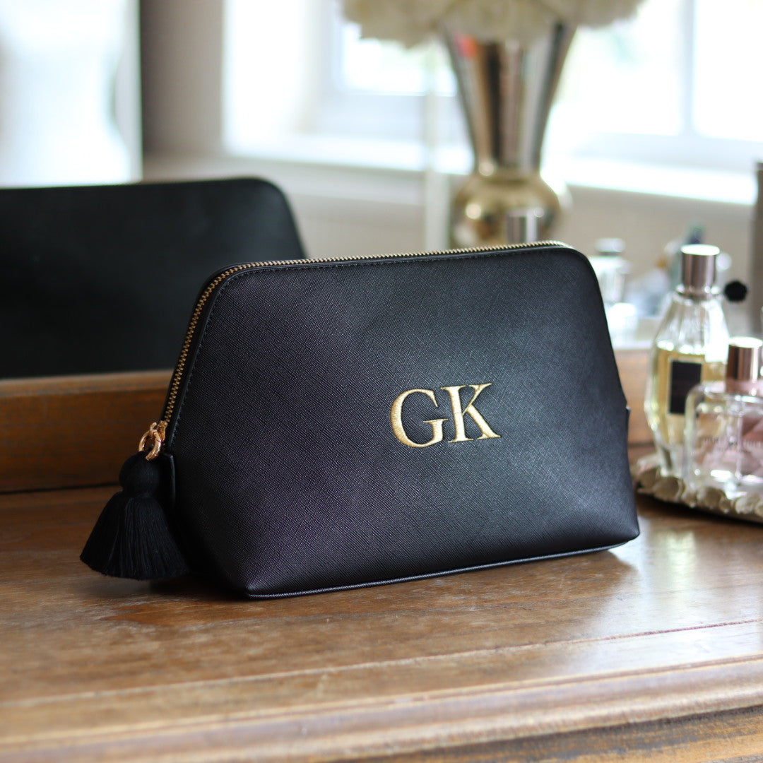 Personalised black faux leather makeup/clutch bag with gold embroidered monogram initials and matching black tassel zipper. Custom travel, cosmetics pouch gift for her.