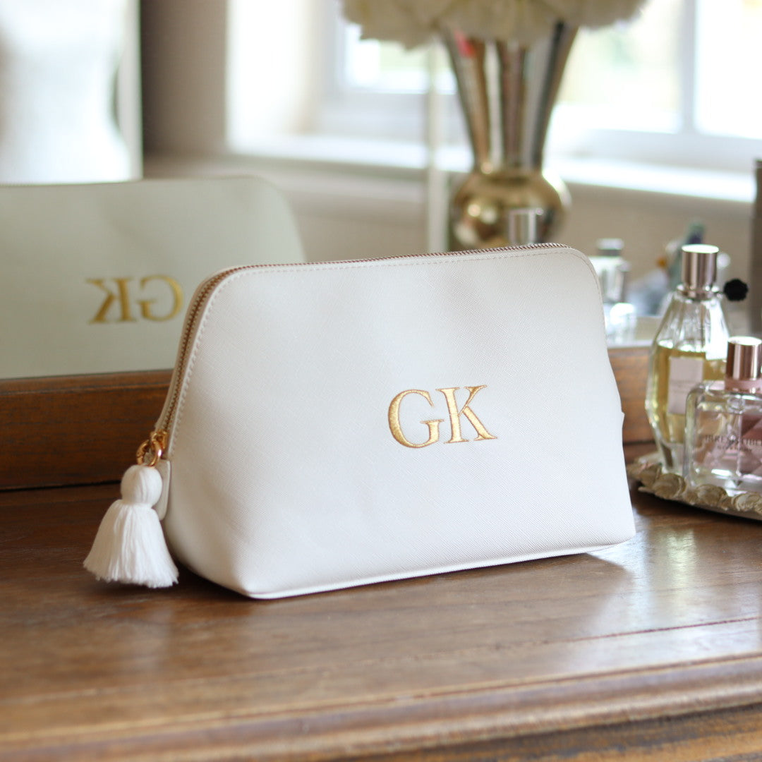 Personalised white faux leather makeup/clutch bag with gold embroidered monogram initials and matching white tassel zipper. Custom travel, cosmetics pouch gift for her.
