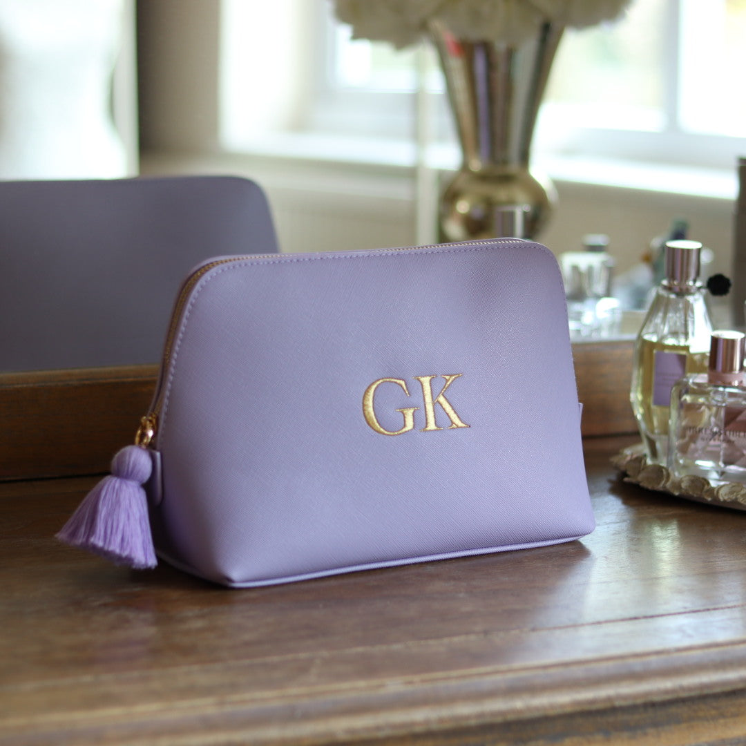 Personalised lilac faux leather makeup/clutch bag with gold embroidered monogram initials and matching lilac tassel zipper. Custom travel, cosmetics pouch gift for her.