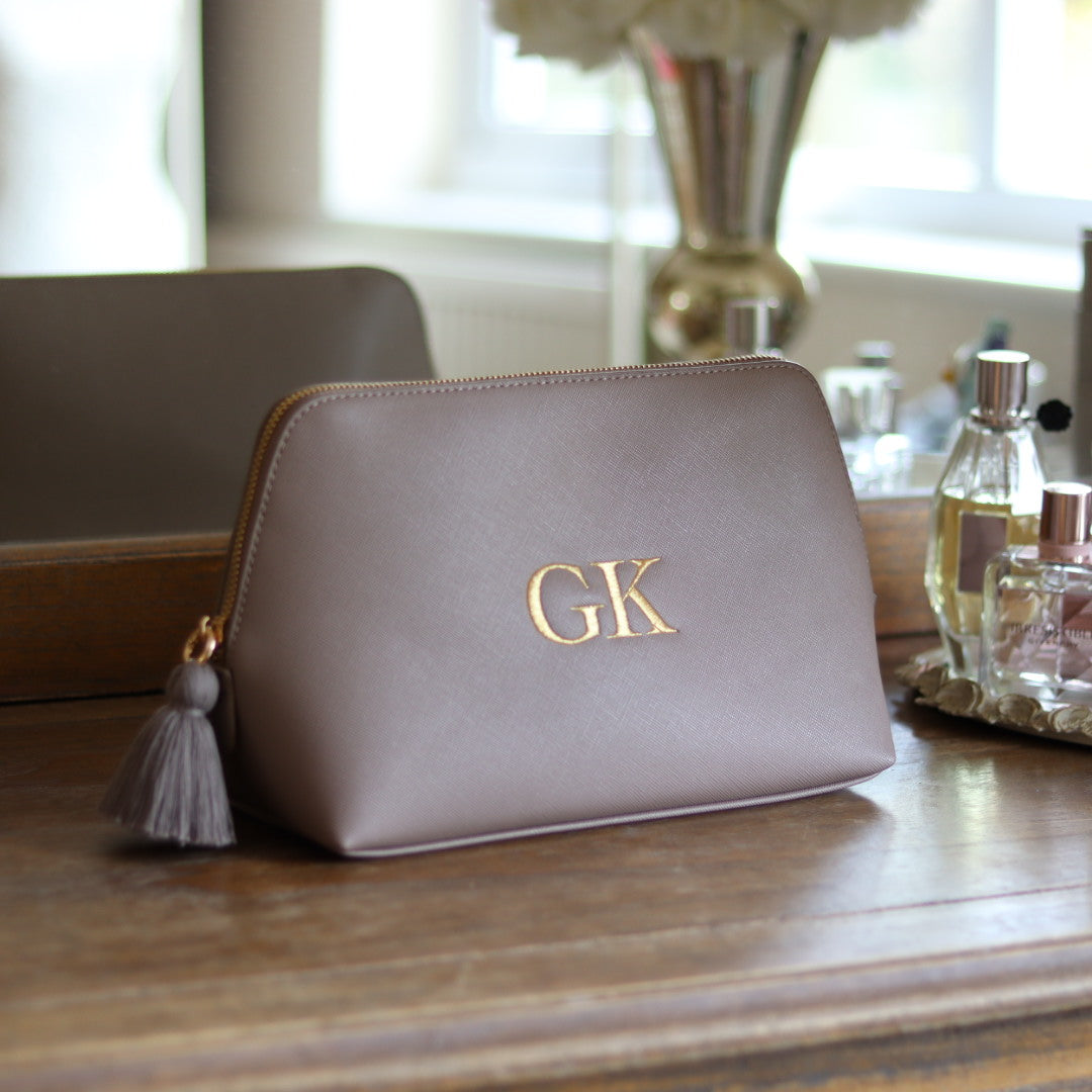 Personalised taupe faux leather makeup/clutch bag with gold embroidered monogram initials and matching taupe tassel zipper. Custom travel, cosmetics pouch gift for her.
